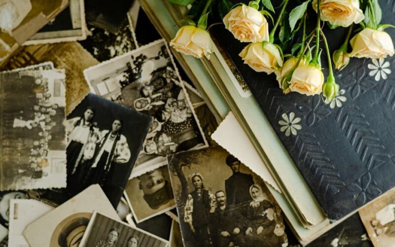 symbols-for-family-a-collection-of-old-family-photographs-and-flowers-on-a-table